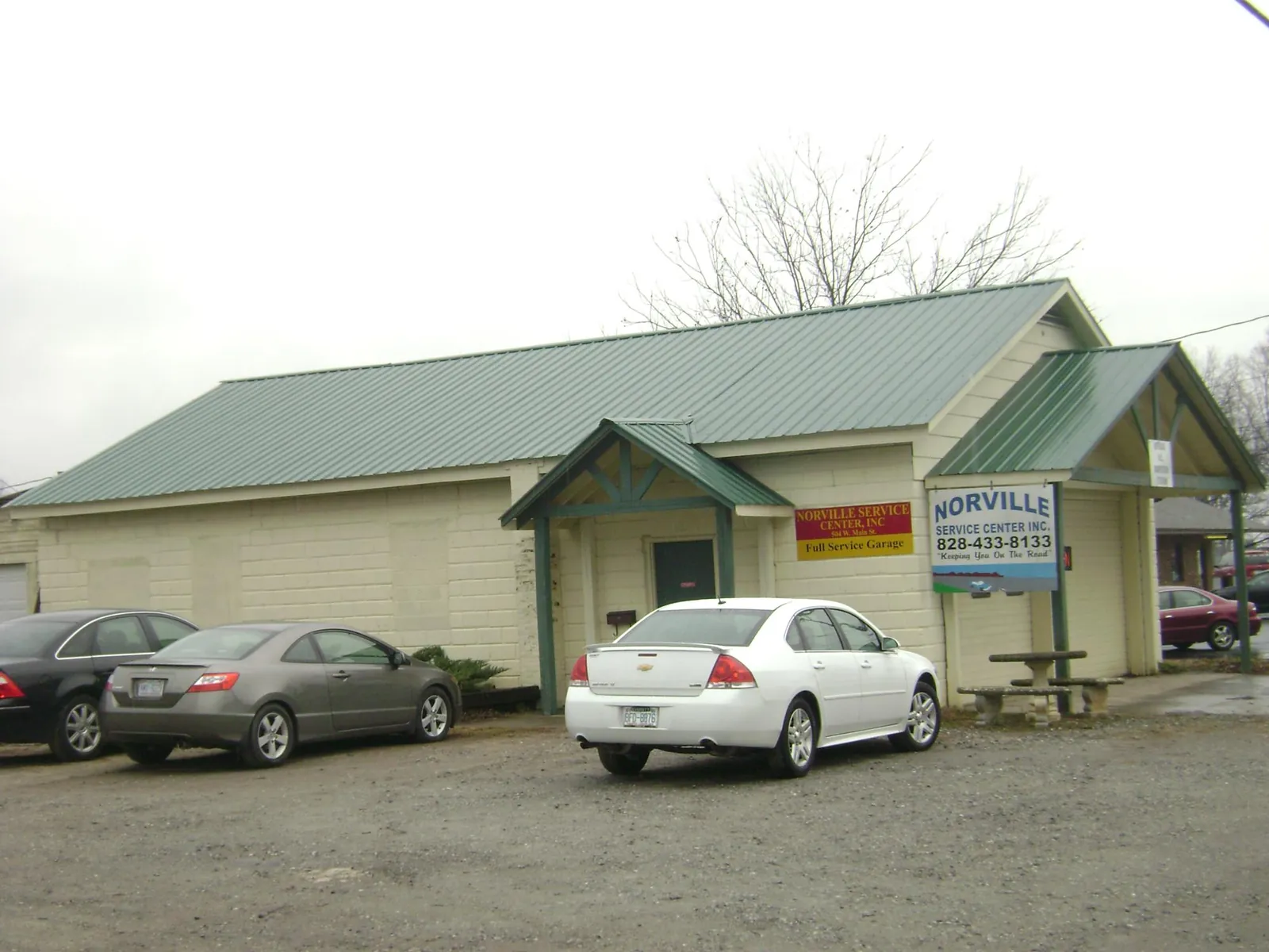 Green metal roof on a service garage with a covered entry in Chico